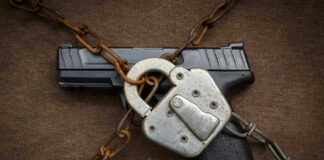 Pistol locked with chains and a padlock.