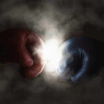 Red and blue boxing gloves clashing with smoke.