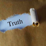 Feds Target Wrestling Cover-Up Ripped paper reveals word truth underneath brown surface