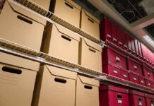 Shelves filled with brown and red storage boxes for organizing documents