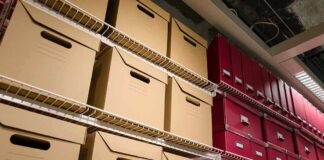 Shelves filled with brown and red storage boxes for organizing documents