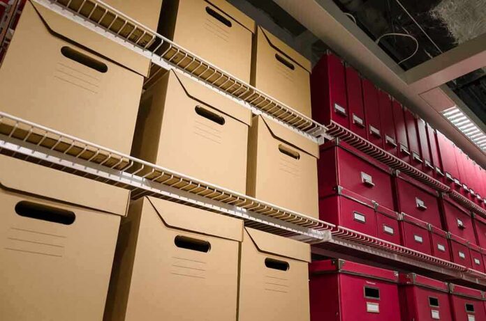 Shelves filled with brown and red storage boxes for organizing documents