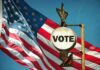 A vintage Vote sign in front of an American flag
