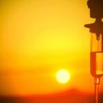 Wisconsin’s Iron Fist GONE After Divine Warning Silhouette of an IV drip against a sunset background