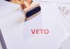 A stamp with the word 'VETO' in red ink on a white document