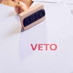 GOP Triumphs: Veto Overridden! A stamp with the word 'VETO' in red ink on a white document