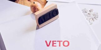 A stamp with the word 'VETO' in red ink on a white document