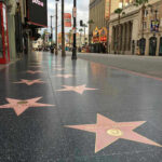 Hollywood Walk of Fame stars on sidewalk.