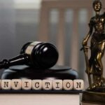 A gavel and the word 'CONVICTION' spelled with wooden blocks