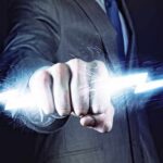 A business professional in a suit with a fist emitting a lightning bolt