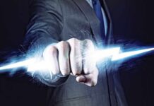 A business professional in a suit with a fist emitting a lightning bolt