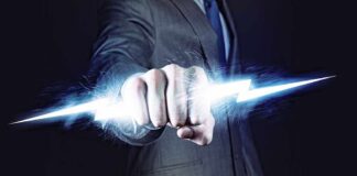 A business professional in a suit with a fist emitting a lightning bolt