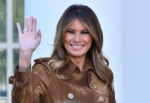 Melania Makes HISTORY–CHAIRS Security Council Melania Trump waving and smiling while wearing a stylish coat