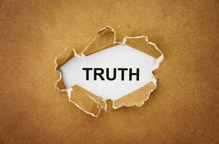 A piece of torn paper revealing the word TRUTH underneath