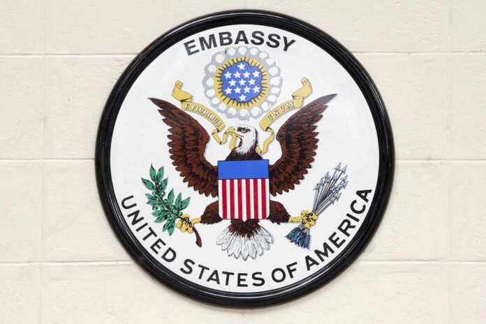 Seal of the United States Embassy featuring an eagle and the American flag