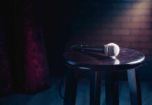 YouTube Karaoke? STAR’S “COMEBACK” Stuns Fans Microphone resting on a stool on stage.