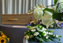 Young Man Euthanized For BLINDNESS! White roses in front of a casket.