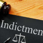 DOJ Indictment Blasts “Hate Watchdog” Gavel next to indictment document on wooden table.