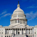 US Capitol Building against blue sky.