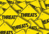 Yellow warning signs with the word THREATS.
