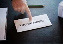 Envelope with YOURE FIRED and pointing finger.