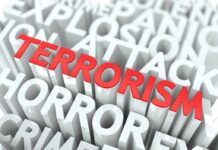 The word TERRORISM in bold red letters surrounded by related terms in white