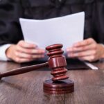Hollywood Drug Pipeline Busted A judge holding documents with a gavel in the foreground
