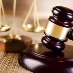 Courts SLAM Trump Citizenship Order A wooden gavel and scales of justice on a table
