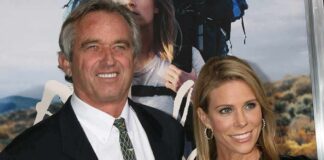 Two smiling individuals posing together at a premiere event