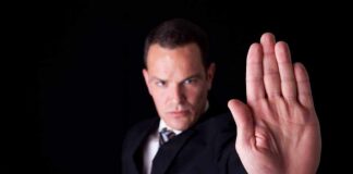 Businessman in a suit making a stop gesture with his hand