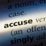 Close-up dictionary definition of accuse underlined.