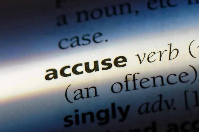 Close-up dictionary definition of accuse underlined.