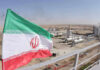 Aerospace Student’s SHOCKING Execution—CIA Involvement? Iranian flag near an industrial gas refinery.