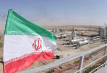 Aerospace Student’s SHOCKING Execution—CIA Involvement? Iranian flag near an industrial gas refinery.