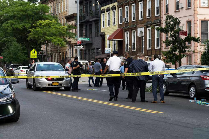 Police gathered at an urban crime scene.