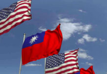 Taiwan Arms Deal In Limbo American and Taiwanese flags waving in the sky.