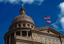 Furious Senators Rage Over Endorsement Building dome with US and Texas flags, blue sky.