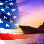 American flag overlaying warship at sunset.