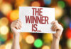 NON-CITIZEN Candidate’s SHOCKING Win! Hands holding a sign reading The Winner Is...