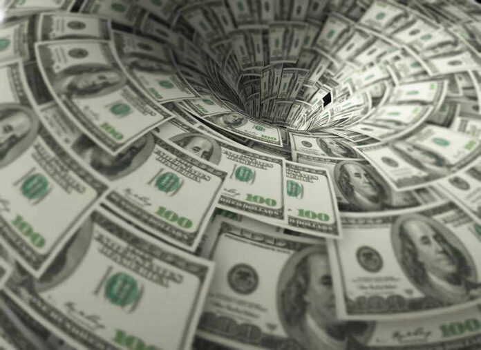 760572118 Hundred-dollar bills swirling into a financial vortex.