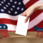 Election Mayhem: STATE’S MAJOR Ballot MIX-UP A hand placing a ballot into a box with political symbols on either side against a backdrop of the American flag