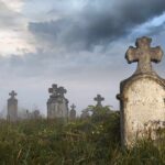 SHOCKING — Historic Cemetery Desecrated Foggy graveyard with tombstones and crosses under a cloudy sky