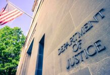 HUGE SCANDAL Erupts: TOP Prosecutor in HOT WATER Exterior view of the Department of Justice building with an American flag