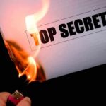 Hunter Drops BOMBSHELL: Dark SECRETS REVEALED A hand holding a lighter igniting a paper labeled TOP SECRET as it catches fire