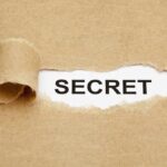 Secret Talks EXPOSED: Trump’s BIG BET on Iran A torn piece of brown paper revealing the word SECRET underneath