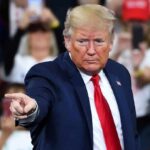 Trump’s GAME-CHANGING Midterm War Machine A speaker at a rally pointing towards the audience