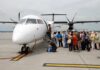 Passengers boarding a small aircraft at an airport