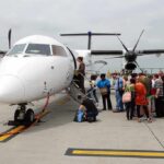 Passengers boarding a small aircraft at an airport
