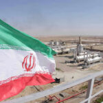 A Deal Brings Calm: Gulf Allies Warn the Danger Isn’t Gone Iranian flag near an industrial gas refinery.