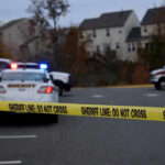 Georgia Hit-and-Run Ejects Child From Truck Sheriff line tape blocking scene with police and ambulance.